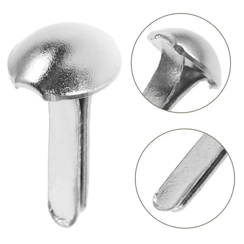 Close-up of silver iron brads from Shadow Puppet Craft Kit With 100 Iron Brads For Puppet Making, Paper Fasteners For Scrapbooking And Do It Yourself Decor.
