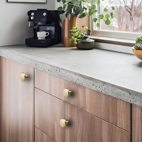 Gold Cabinet Knobs Set installed on wooden dresser under concrete countertop, Round Brushed Brass Zinc Alloy Hardware, 25 Pack by Homdiy