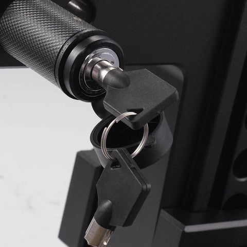 Close-up of a locking mechanism with keys inserted, part of a Five Eighth Inch Trailer Hitch Lock With Extra Long Four And A Half Inch Span For Three Inch Receivers Plus Two And A Half Inch And Two Inch Adapters Anti Rattle O Rings Locking Hitch Pin To Keep Your Trailer Truck Or Car Safe, showing textured grip and metal finish.