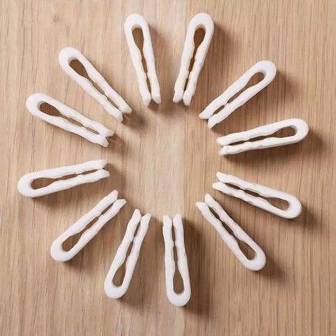 10 Pack Vacuum Bag Clips With Sliding Grip For Tight Seals, arranged in a circle on a wooden surface. Reusable and airtight.