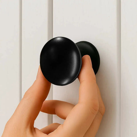 Hand installing Matte Black Large Bifold Closet Door Knobs Four Pack With Renovation Ready Wide Base Zinc Round Kitchen Wardrobe