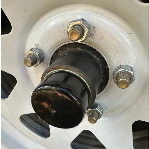 Close-up of 2 Inch Rubber Wheel Hub Trailer Bearing Dust Cap Plug Grease Cover installed on trailer wheel hub