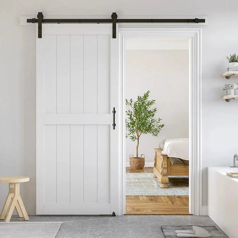 36 By 84 Inch White Sliding MDF Barn Door With Six Point Six Foot Black Sliding Door Hardware Kit And Handle Pre Drilled Ready To Assemble Waterproof PVC Coating H Frame Durable Primed MDF And PVC Construction For Water Resistance And Stable Performance installed in a living space.
