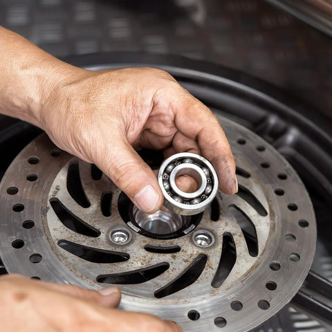 uxcell 682ZZ deep groove ball bearing, chrome steel, double shielded, held over a perforated brake rotor.