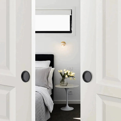 Bedroom scene with white closet doors using 4 Pack Closet Door Finger Pulls For 2-1/8 Inch Holes Stainless Steel Sliding Door Hardware With Easy Snap-In Installation No Nails Needed Durable Finger Pulls For Smooth Closet Door Operation And Quick DIY Replacement, featuring black round handles.