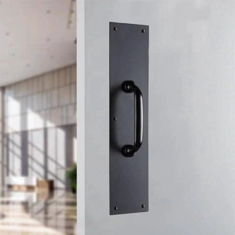 Commercial 15 Inch Stainless Steel Pull Door Plate In Matte Black Finish mounted on a door, pre-drilled for industrial duty entrances.