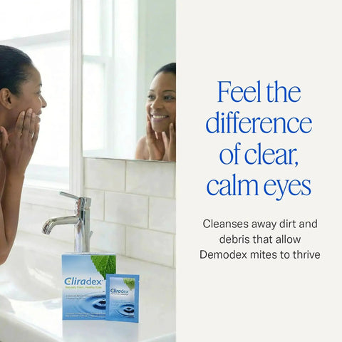 Woman smiling at mirror with Natural Eyelid Towelettes for Demodex and Blepharitis Cleanser with Tea Tree Oil on the counter.