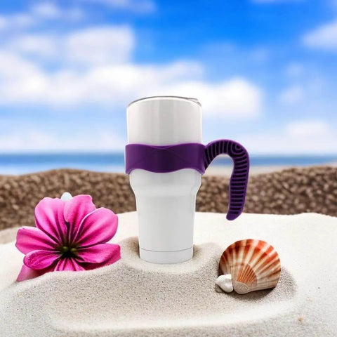 White mug with purple 30 Oz Tumbler Handle With Anti Slip Grip For Vacuum Insulated Mugs on beach sand with flower and shell