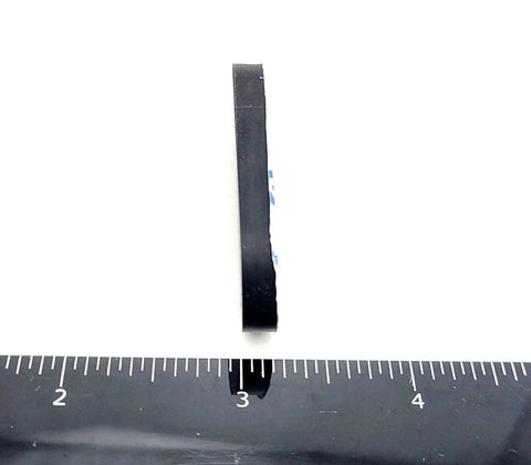 Side view of 2 Inch By 3/4 Inch Oval Silicone Bumper Feet 3/16 Inch Thick with ruler for scale, showing adhesive backing.