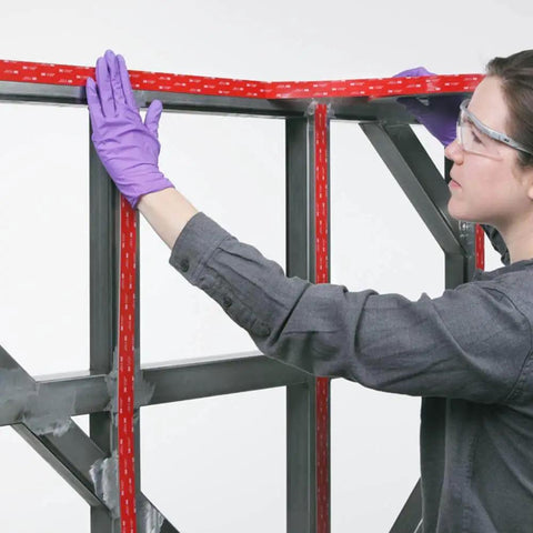 Person applying VHB 5915 Permanent Bonding Conformable Black Double-Sided Acrylic Tape 1 in x 15 ft to a metal frame