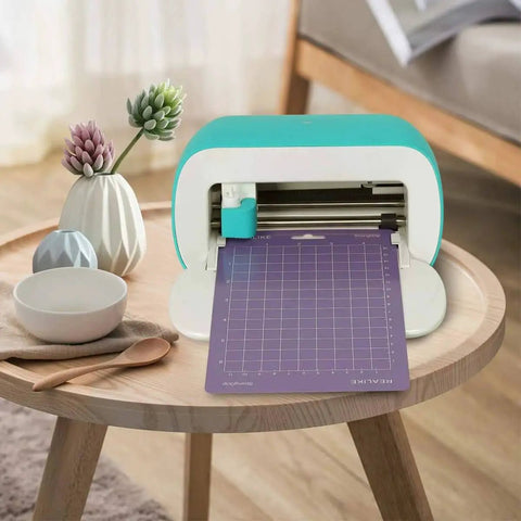 Versatile Cutting Mats For Cricut Joy 4.5 By 12 And 4.5 By 6.5 Inch 6 Pack Including Standard Grip Light Grip And Strong Grip Mats With Adhesive Backing For Joy Accessories And Creative Projects loaded in a Cricut Joy machine on a table.