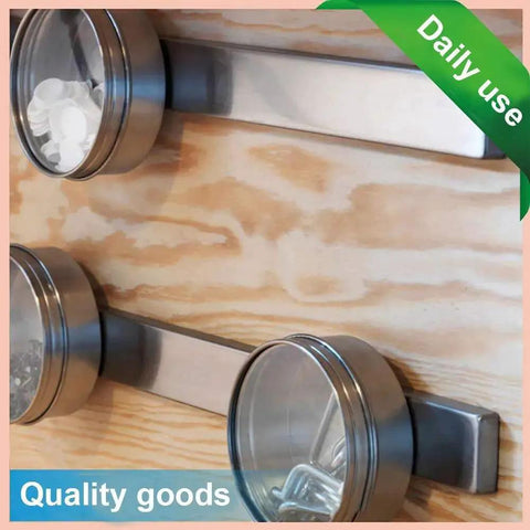 16-pack neodymium magnets with double-sided adhesive; silver metal discs mounted on wood surface (angled view)