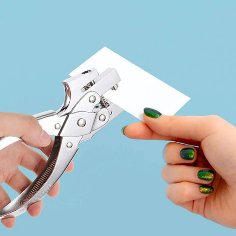 Hand using Heavy Duty Single Hole Punch Plier For Office And Crafting Handheld Paper Punch Tool For Cardstock Loose Leaf Sheets Badges