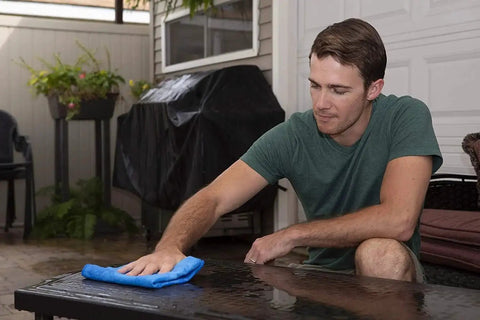Person using Large 27x17 Inch Drying Chamois Cloth For Cars Super Absorbent Washable on a glass table surface