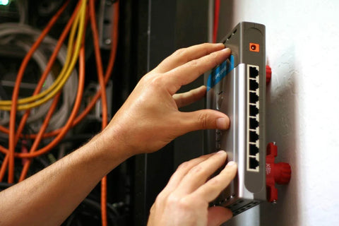 Person installing a device on a wall near various cables, using Slot Marking Tool Set For Keyhole Slots And Hangers Without Measuring Or Templates No Guesswork Needed Recessed Marker Keeps Surfaces Clean While You Align Hangers Sawtooth Hooks And Keyhole Slots With Ease