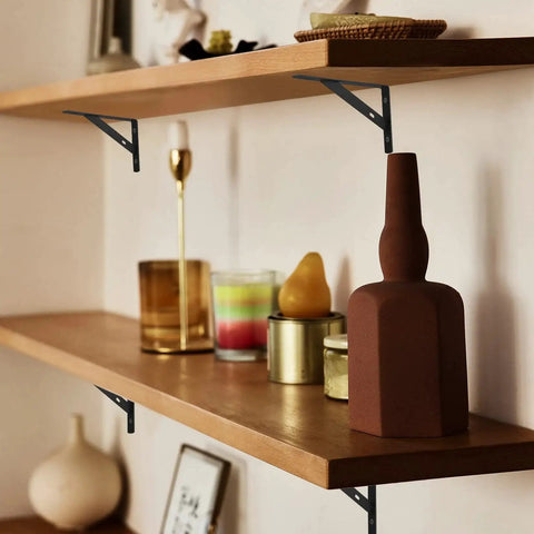Floating shelves supported by 8 Piece L Shaped Metal Shelf Brackets, heavy duty iron with rust resistant finish, installed with decor items.