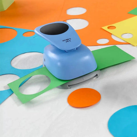 Blue 2.5 inch circle punch cutter on paper for scrapbooking and crafts, two and a half inch circle hole punch cutter visible