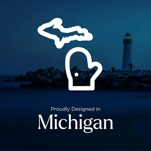 Stylized Michigan map and mitten icon with a lighthouse in the background, text 'Proudly Designed in Michigan' underneath.