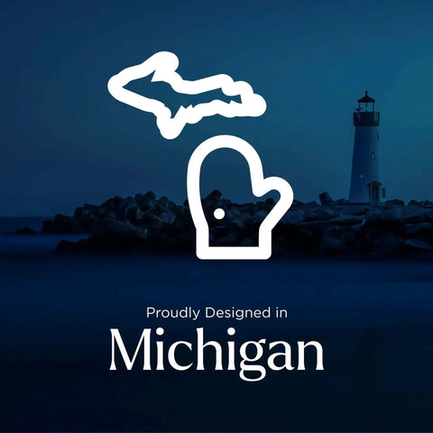 Silhouette of Michigan state map and mitten with lake lighthouse background, text 'Proudly Designed in Michigan.'