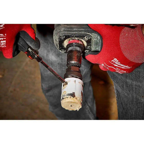 Person using drill with Ice Hardened Three And A Quarter Inch Bi Metal Hole Saw With Matrix II Teeth For Faster Cuts And Longer Life Built For Tough Jobs That Delivers Up To Fifty Percent Longer Life Compared To The Competition Pro Grade By Milwaukee