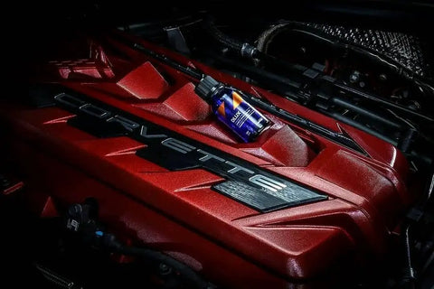 30mL bottle of DLUX Wheel and Trim Ceramic Coating with UV Protection on a red engine surface