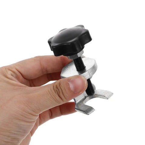 Hand holding Universal Windshield Wiper Arm Puller And Bearing Removal Tool For Vehicle Repair And Automotive Maintenance.