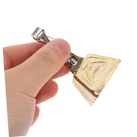 Close-up of a stainless steel fishing rod bite alarm bell with clip, part of a 15-piece set for freshwater and saltwater use.