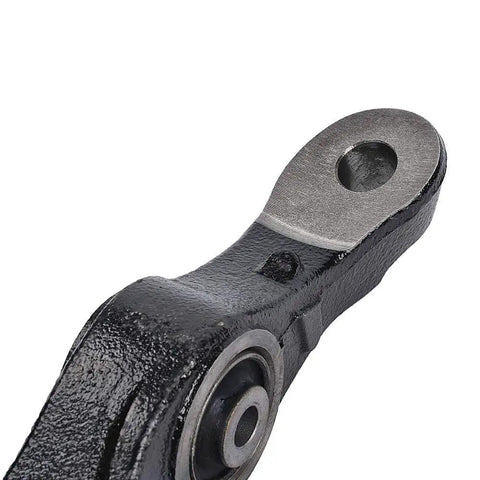 Close-up of black metal front suspension lower control arm end with mounting bore and visible bushing.