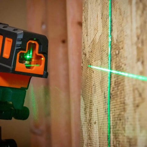 Compact Self Leveling Laser Level With Plumb Spot, Bright Green Cross Lines, 75 Foot Range, Class 2 Laser attached to wood surface