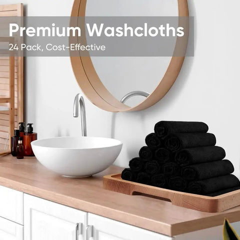 Black Microfiber Washcloths 24 Pack 12x12 Inches for Makeup Removal and Spa displayed on a bathroom counter next to a sink and mirror.