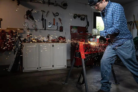 Person using an angle grinder emitting sparks with Aggressive Four And A Half Inch Cut Off Wheels Pack Of Five For Angle Grinders General Purpose Cutting Discs With Norton Aluminum Oxide Grain And Proprietary Bond For Long Life And More Cuts Per Wheel When Cutting Metal And Stainless Steel.