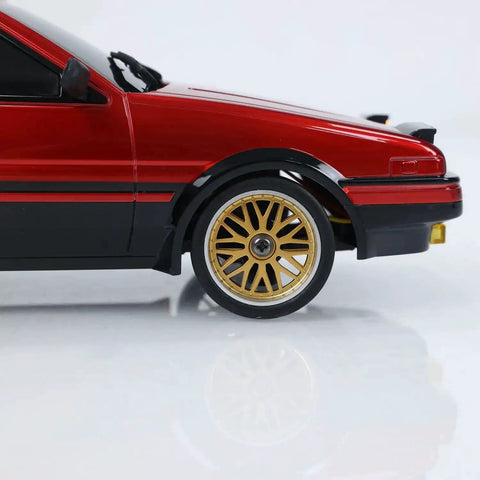 Close-up of One Eighteen Scale RC Drift Car With Gyro Stabilization In Vintage Red showing gold wheels and detailed side view