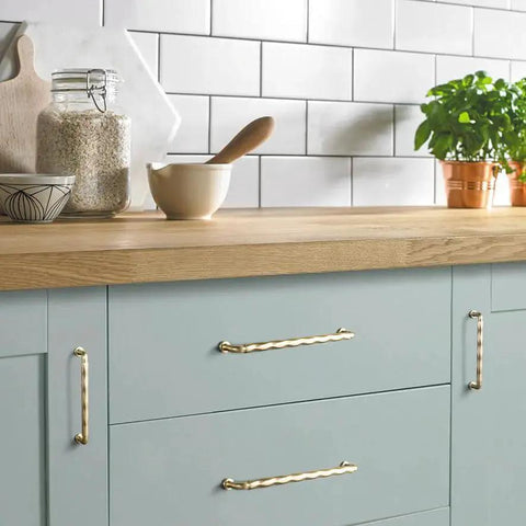 Champagne Bronze Cabinet Pulls 3 Inch Twisted Wave Design Set on modern kitchen drawers, showcasing zinc alloy construction.