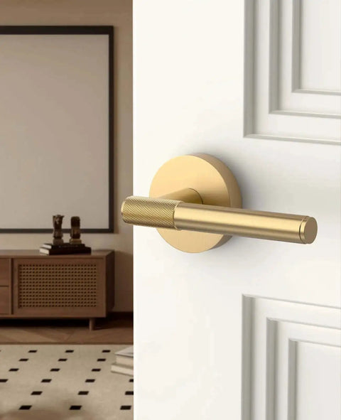 Champagne Bronze Passage Door Handles Set Six Pack showing installed lever on a white door