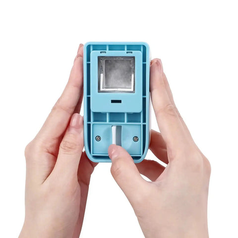 Hands holding a 1 Inch Square Hole Punch For Crafting And Scrapbooking, showcasing the lever mechanism and stainless steel blade.