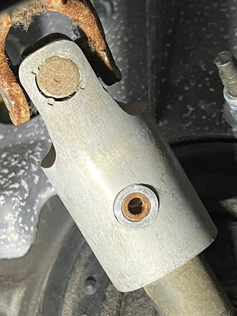 Close-up of a Blue Anodized Billet Aluminum Steering Column Sleeve and Bushings for Ram 03-19, showing installed view.