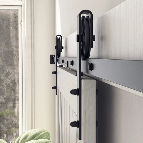 Side view of installed Beefy 8 Foot Sliding Barn Door Hardware Kit Black Track System with steel big wheel hangers on a wooden door.