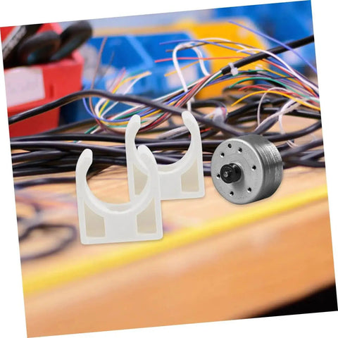 20 Piece Small Electric Motor Clamp Bracket Mounting Brackets For DC Brush Motors Geared R280 Compatible Built For DIY Toy Builds And Hobby Projects Sturdy Secure Heavy Duty Motor Mount with two white plastic clamps and motor on workbench.