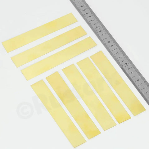 10 Piece Brass Strip Assortment Kit With Handy Brass Shim Sheets For Metalworking And DIY Projects, 1 Inch Wide By 5.9 Inch Long, 0.004 Inch Thick, Durable And Reliable Shims shown with a ruler for scale.