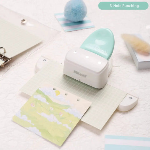 Go To 3 Hole Punch And 12 Piece Metal Ring Binder Set for A5 to A8 notebooks, showcasing mint green 3-hole punch tool in action