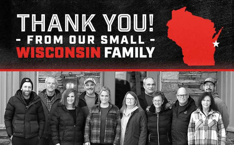 Group of people standing in front of a building with 'Thank You! From Our Small Wisconsin Family' text and Wisconsin map