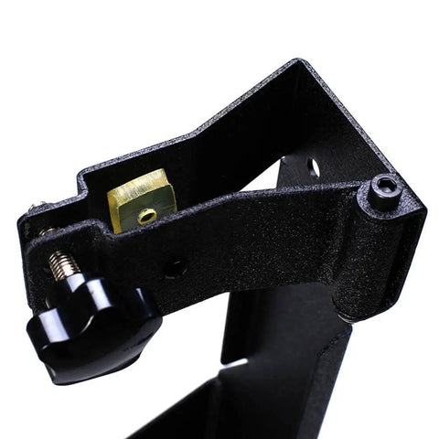 Close-up of a metal rear high lift jack mount carrier for 2007-2017 Jeep Wrangler JK showing bolt-on design and hinge attachment.