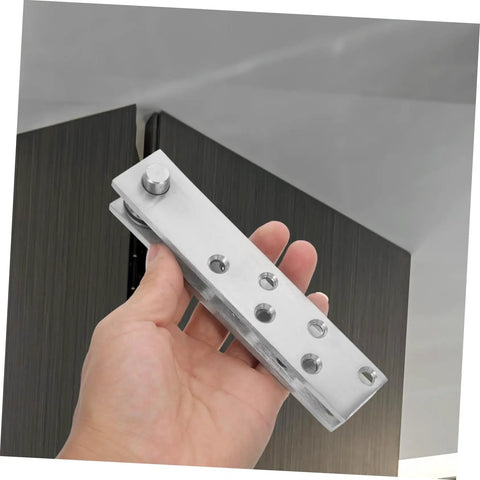 Hand holding 360 Degree Heavy Duty Stainless Steel Pivot Hinges For Hidden Doors With Slick Operation And Concealed Invisible Hinge System
