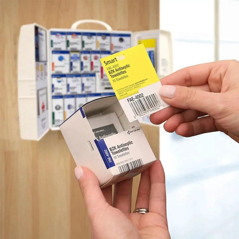 Hand holding antiseptic towelette from OSHA Compliant 50 Person Workplace First Aid Kit With 245 Pieces In Large Plastic Cabinet Ready For Any Office Or Job Site Featuring SmartCompliance SmartTab ezRefill System By First Aid Only
