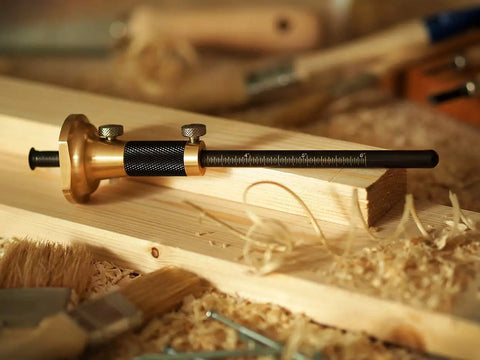 Pro Grade 7 Inch Brass Wheel Marking Gauge Kit With Anti Roll Fence, shown on wood shaving surface with micro adjuster.