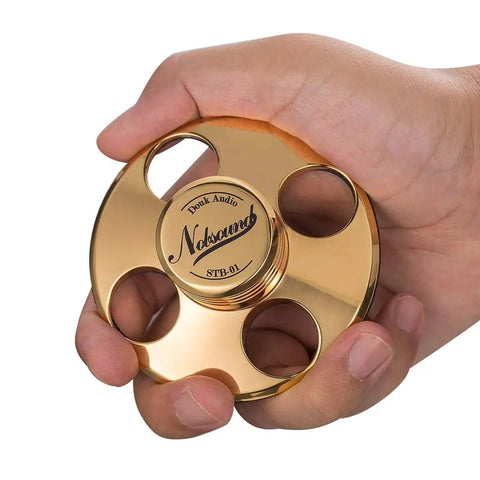 Person holding LP Vinyl Turntable Stabilizer Disc Weight For Reducing Resonance And Noise Floor, Improving Image And Focus, Realistic Sound Reproduction With Gold Finish HiFi Build Nobsound STB01