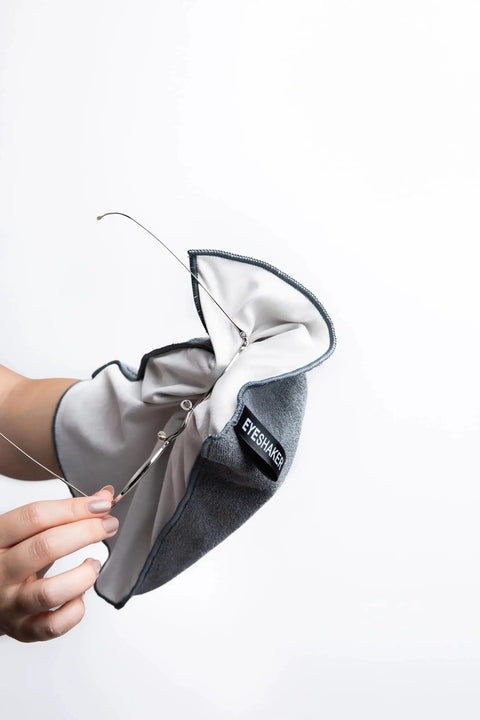 Person cleaning glasses with Premium Microfiber Glass Cleaning Cloth 30x20 Cm For Glasses Phone Screens.