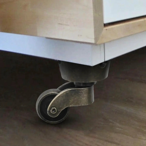 Installed two pack vintage zinc alloy swivel caster wheels with antique green bronze finish under furniture piece