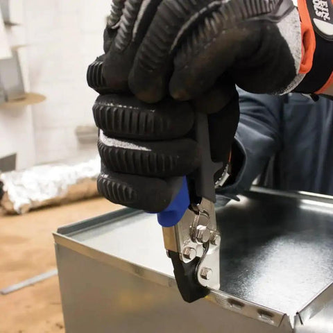 Worker using Punch Set Snap Lock Handy Tool For Sheet Metal, Vinyl And Aluminum Siding, Creates Three Eighths Inch Impressions.