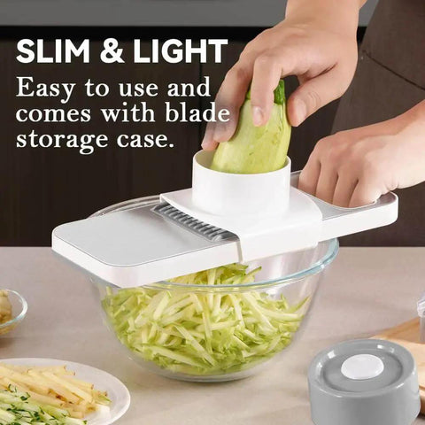 Using Versatile Mandoline Slicer KEOUKE With Six Interchangeable Blades Magnetic Back And Safe Hand Guard to slice cucumber into a bowl.